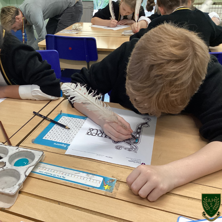 A boy writing with a feather pen