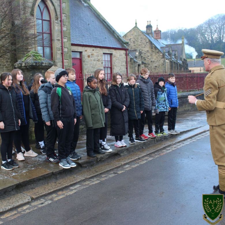 Children learning how to march from a solider 