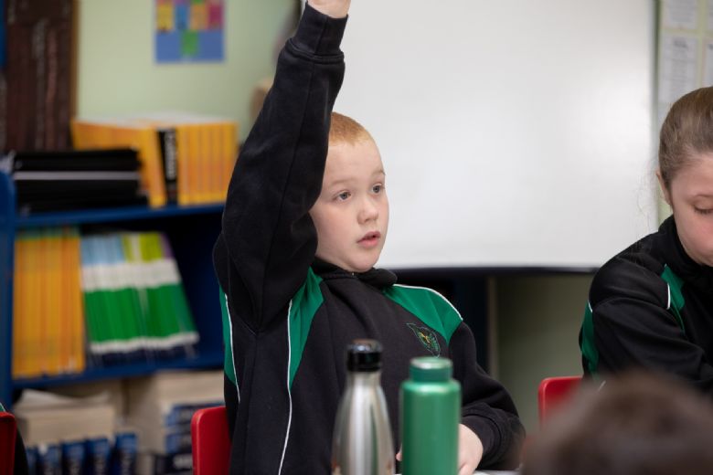 A young boy waiting to answer a question